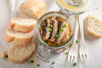 Healthy smoked sprats on white food paper.