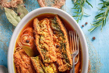 Fresh roasted mackerel in vinegar with onion and spices.