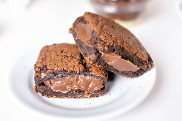 two brownies served on a white plate