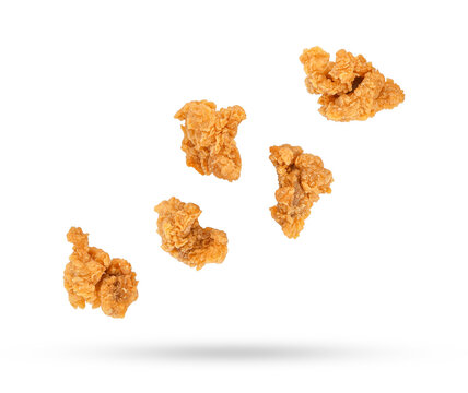 Fried Popcorn Chicken Falling In The Air Isolated On White Background.