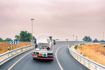 Truck transporting refrigerated liquid gases, with a plate of dangerous goods, circulating on the highway.