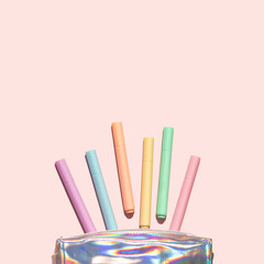Minimal composition with colorful highlighters and pencils case on pastel light pink background. Minimal back to school idea. Creative education concept.