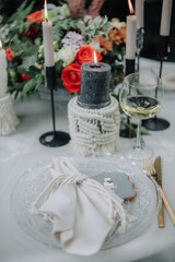 Obraz na płótnie Canvas Modern wedding table decorated with plates, cutlery and flowers