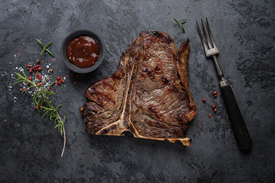 Grilled juicy steak on dark background