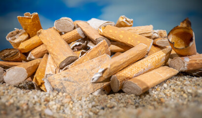 Cigarette stubs on a sandy beach