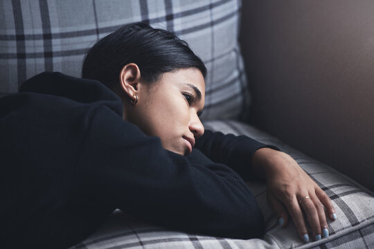 Depression, Mental Health And Woman Thinking About A Sad Memory Feeling Upset And Grief After Suffering A Loss. Stressed, Depressed And Disappointed Girl Worried About A Personal Problem On The Sofa