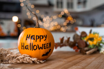 A vase of flowers,a jack pumpkin and candles on a tray. In the background - the interior of a white...