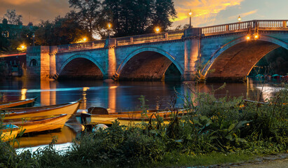 Richmond Upon Thames River illuminated at night in the fall season, in London City, England -...