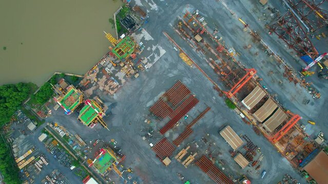 4K : Drones are flying over a large steel plant during cloudy day, many machines are working, exterior of a large metallurgical plant. steel industry. infrastructure industry
