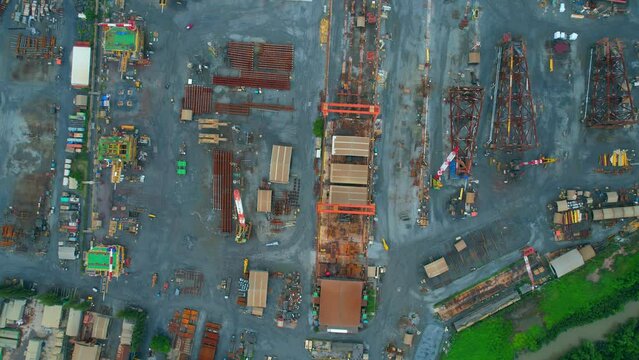 4K : Drones are flying over a large steel plant during cloudy day, many machines are working, exterior of a large metallurgical plant. steel industry. infrastructure industry
