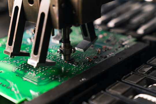 Close up of SFD surface-mount device assembling electrical components on PCB printed circuit board. Modern technology. Horizontal shot . High quality photo