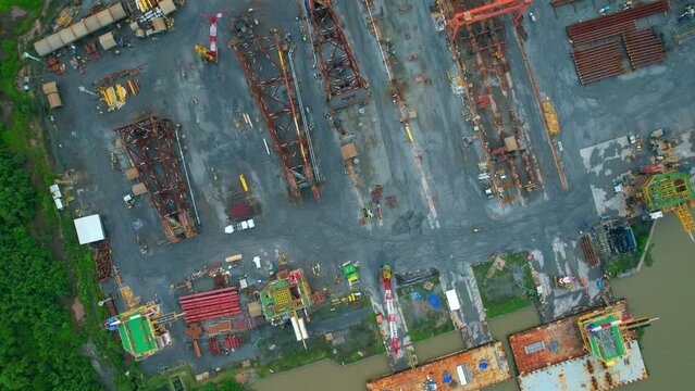 4K : Drones are flying over a large steel plant during cloudy day, many machines are working, exterior of a large metallurgical plant. steel industry. infrastructure industry
