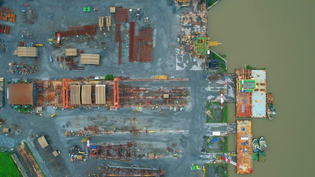 4K : Drones are flying over a large steel plant during cloudy day, many machines are working, exterior of a large metallurgical plant. steel industry. infrastructure industry
