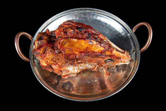 Roasting head of a lamb. Traditional Turkish Offal Food Kelle Sogus, Lamb Head Meat with Brain Served Portion served on a copper plate.