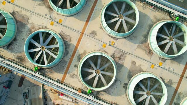 Aerial view from drone flying over industrial cooling tower. 4k stock footage
