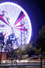 Fototapeta premium Ferris wheel in Antalya night with blurred lights lines