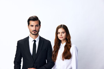 Man and woman smile with teeth business in business attire looking into camera on white isolated background. Stylish business concept paired between employees startup copy space