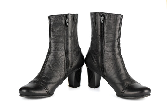 One pair of women's black autumn mid-heel ankle boots with zip fastening.