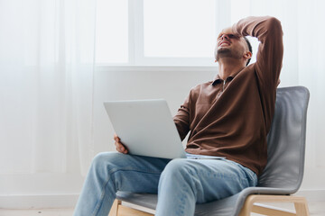 Unhappy tired guy looks at laptop screen doing facepalm hate remote work at home office having problems with connection sitting on chair. Distance communication Career Remote job concept. Copy space