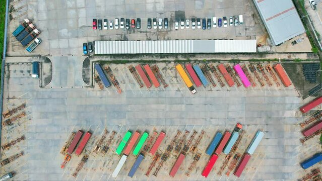4K : Many of Semi-trailer trucks stand at the distribution center. cargo import export shipment. Industrial containers cargo shipment. aerial view footage. drone
