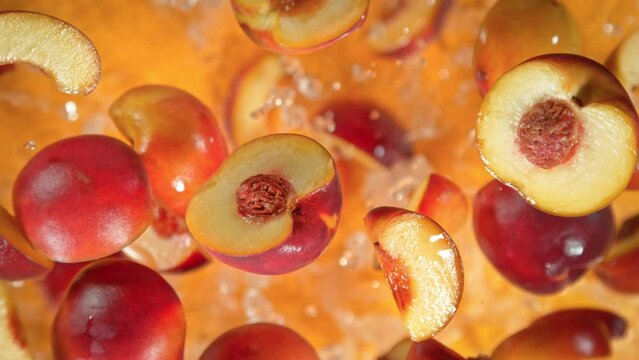 Super Slow Motion Shot of Peach Cuts And Water Flying Towards Camera on Orange at 1000 fps.