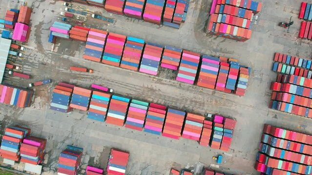 4K : Aerial view from a drone flying over a many cargo containers at distribution center. import and export industry. transportation concept
