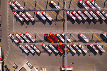 Fototapeta premium Parking, bus bay or bus stop of new TTC BUSES by the Toronto Transit Commission. City public transportation buses in the special garage area. Aerial bird at golden hour and long shadows.