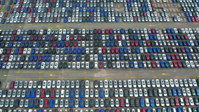 Aerial view from drones flying over a lot of cars. automotive for sale. automobile company concept. import and export industry. 4k stock footage
