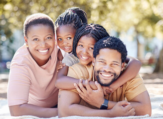 African family smile at the park, having fun in summer sunshine and enjoying nature on holiday. Black African man, woman and children smiling. Kids hug dad, to bond with parent in garden