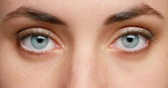 Eye, vision and beauty with the eyes of a woman closeup and looking in focus. Skin, skincare and makeup with the face of a young female with beautiful eyebrows, eyelashes and features in macro detail