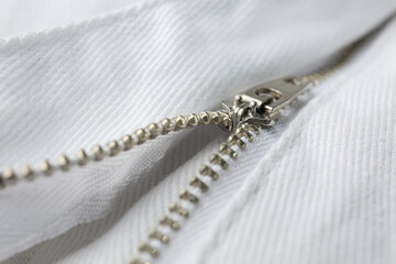 White jacket with zipper as background, closeup view