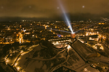 Scenic aerial view of Gediminas tower in Vilnius Old Town beautifully illuminated for 699 birthday celebration. Main symbol of Lithuanian capital at winter night.