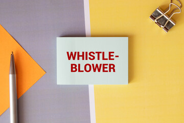 whistle blower text concept on torn paper.