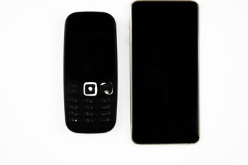 Old mobile phone and smartphone. Smartphone and push-button telephone of the old sample.