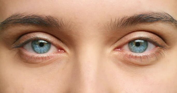 Vision, eyes and woman portrait watching in optometry healthcare, wellness or eyesight exam closeup, macro or zoom. Medical awareness and natural human blue iris for cosmetic beauty or contact lenses