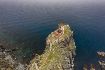 Fototapeta na wymiar An old ruined lighthouse on Askold Island in the East Sea