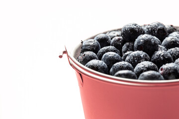 Macro photo of Bucket or bowl full of fresh blueberries on white background