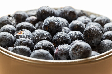 Macro photo of Bucket or bowl full of fresh blueberries on white background