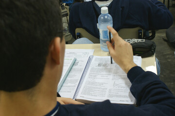 person writing on a paper