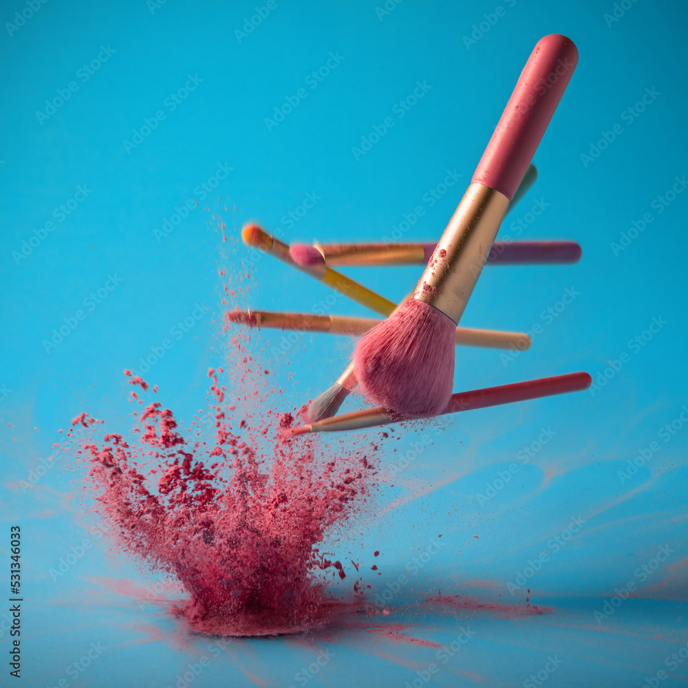 Poster make up brushes with powder splashes isolated on pink background