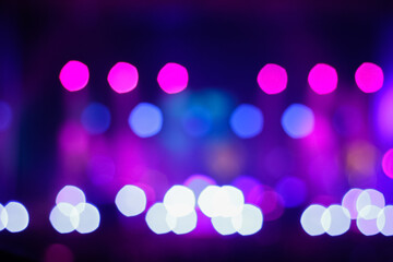 Defocus blurred abstract purple bokeh background. Festive spotted glitter background. Blurry music...