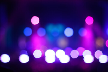 Defocus blurred abstract purple bokeh background. Rock concert performing on stage with musician...