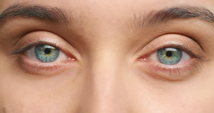 Blue eye of woman with sight to blink, vision and health or optometry in macro zoom in. Iris, retina and focus with eyeball of female lashes for genes, health and light color awareness or perception