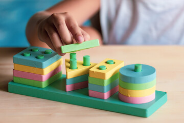 Naklejka premium boy playing children toys for learning for skills