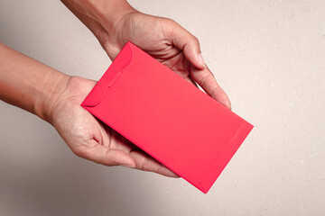 man's hand hold with chinese red envelope,on white background