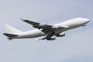 Fototapeta na wymiar Boeing 747-400 All White Colours cargo Aircraft taking off