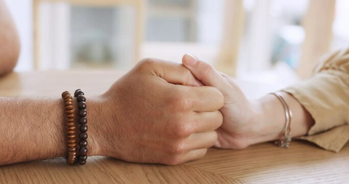 Couple, battle and hand game with man and woman playing thumb war on table, loving and holding hands. Fun, relax and stress free lovers bonding and enjoying being playful, sweet romance in their home