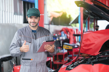 car service, repair, maintenance concept - Arab auto mechanic man or Smith stand beside a car at workshop warehouse before start checking a car in the garage for maintenance services