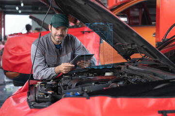 car service ,repair, maintenance concept - Arab auto mechanic man or Smith checking the car performance via  tablet at workshop warehouse before start repair/tunnig the car in the garage