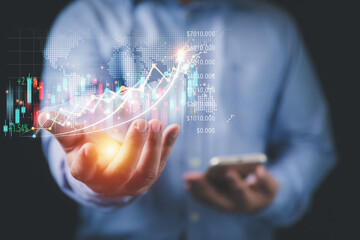 Analysis, strategy, and plan investments for business profit goals. Business, Investment, and Finance concept. Businessman holding growth a graph virtual screen on hand to analyze for investment.